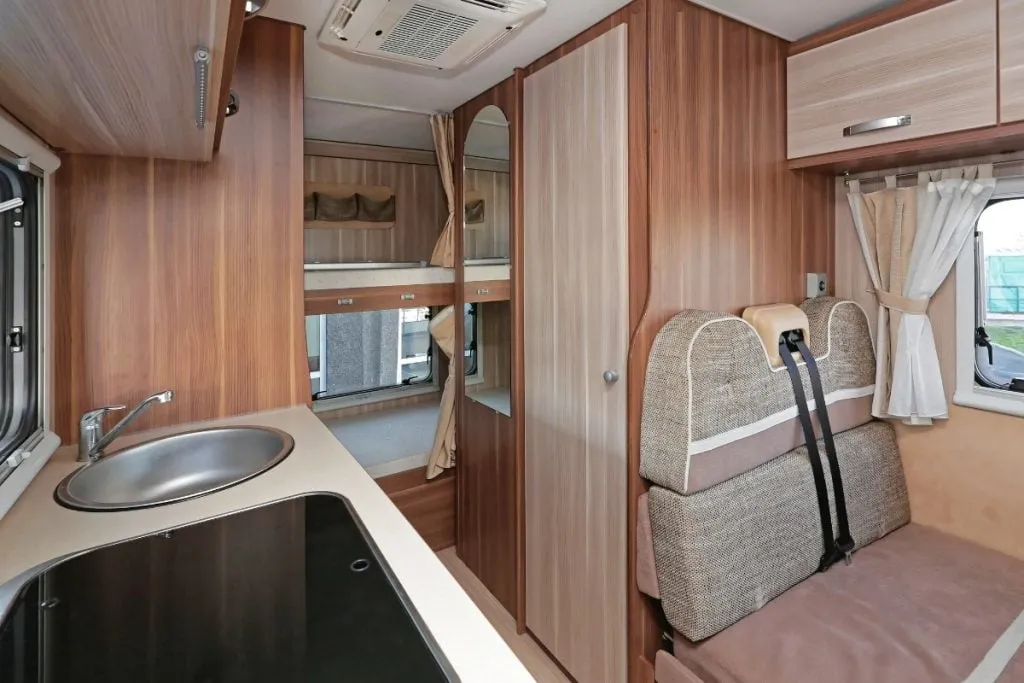 Camperinterieur met keuken, slaapruimte en badkamer